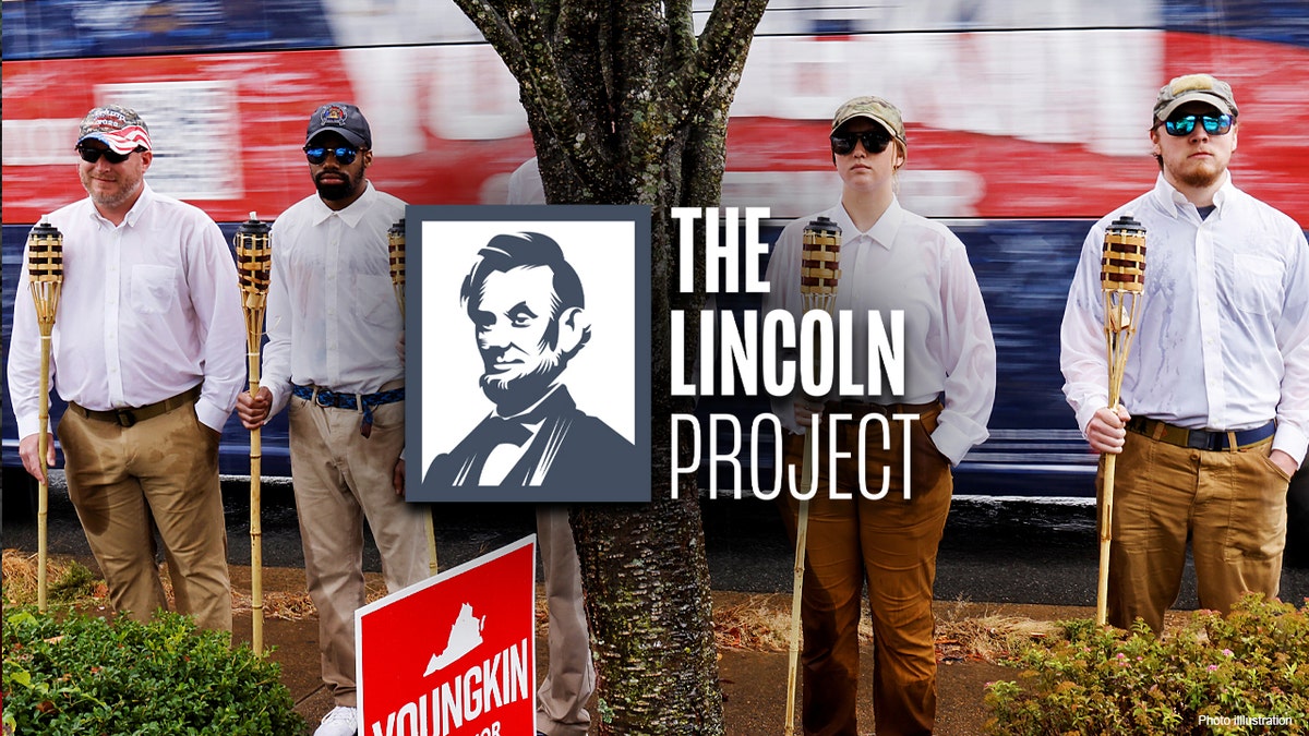 A small group of demonstrators dressed as "Unite the Right" rally-goers with tiki torches stand on a sidewalk as Republican candidate for governor of Virginia Glenn Youngkin arrives on his bus for a campaign event at a Mexican restaurant in Charlottesville, Virginia, Oct. 29, 2021.