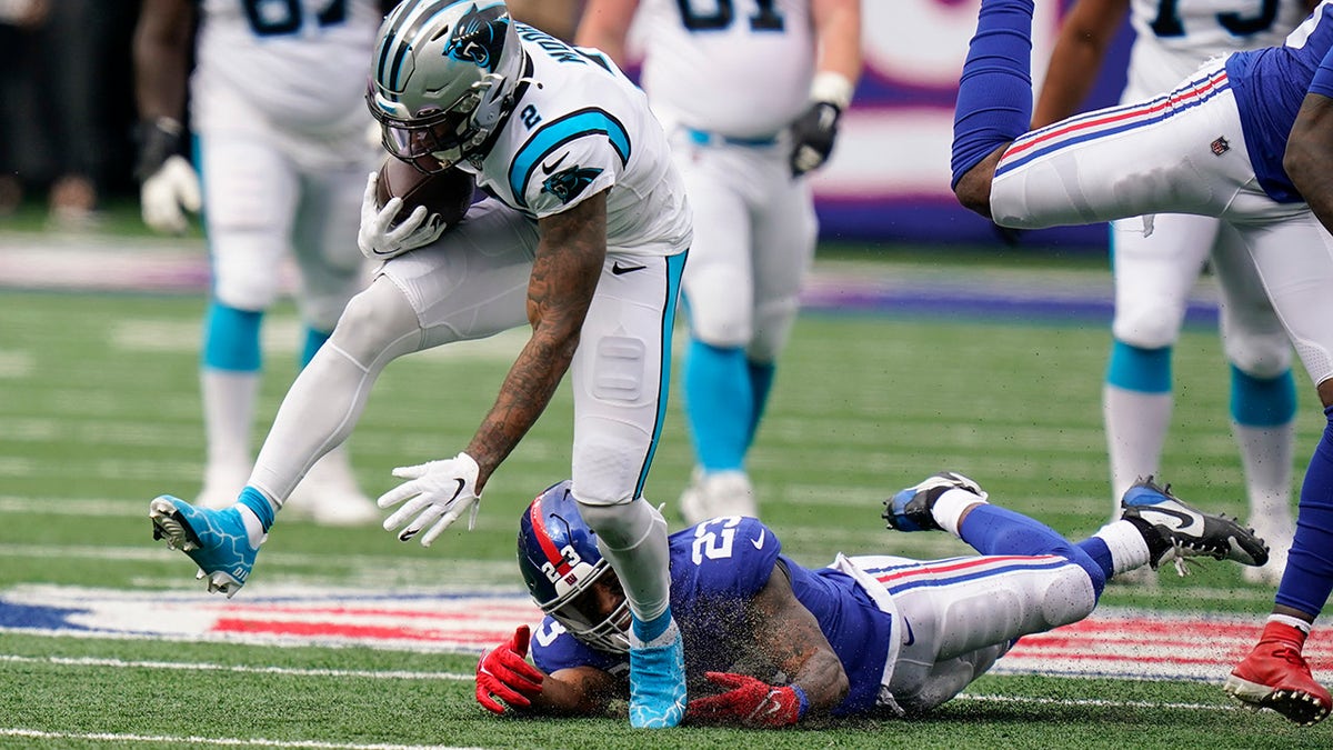 Carolina Panthers wide receiver D.J. Moore (2) breaks a tackle by New York Giants' Logan Ryan (23) during the first half of an NFL football game, Sunday, Oct. 24, 2021, in East Rutherford, N.J.