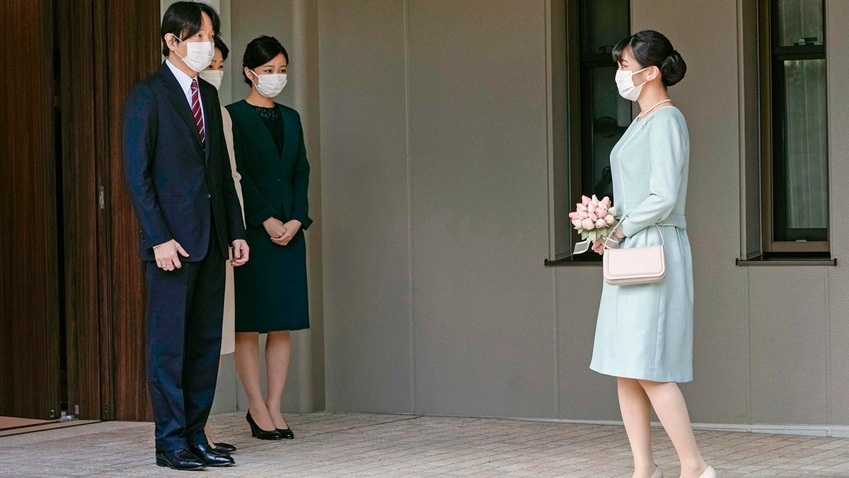 Japan's Princess Mako, right, talks with her parents, Crown Prince Akishino, Crown Princess Kiko, and her sister Princess Kako, third from left, before leaving her home in Akasaka Estate in Tokyo on Tuesday.