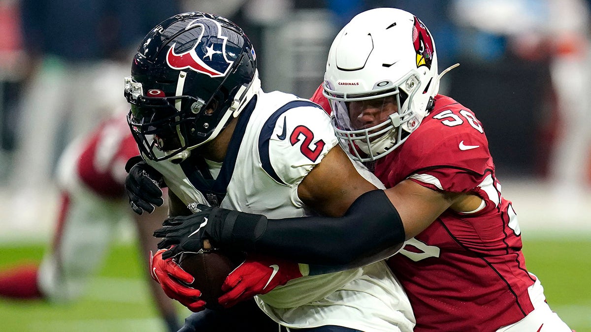 Houston Texans running back Mark Ingram (2) is tackled by Arizona Cardinals middle linebacker Jordan Hicks (58) during the first half of an NFL football game, Sunday, Oct. 24, 2021, in Glendale, Arizona.