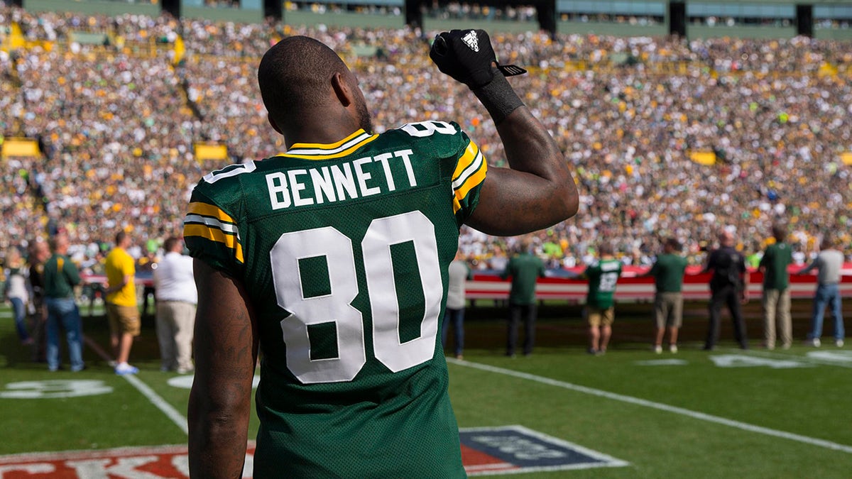Green Bay Packers tight end Martellus Bennett #80 holds his fist in the air during the national anthem prior to the game against the Seattle Seahawks at Lambeau Field on Sept. 10, 2017.