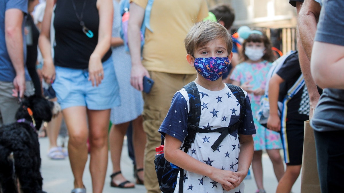 FILE PHOTO: A child wears a face mask on the first day of New York City schools, amid the coronavirus disease (COVID-19) pandemic in Brooklyn, New York, U.S. September 13, 2021. REUTERS/Brendan McDermid/File Photo