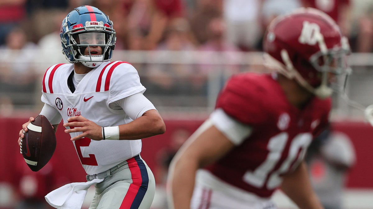 Oct 2, 2021; Tuscaloosa, Alabama, USA; Mississippi Rebels quarterback Matt Corral (2) rolls out to pass against the Alabama Crimson Tide during the first half of an NCAA college football game at Bryant-Denny Stadium.