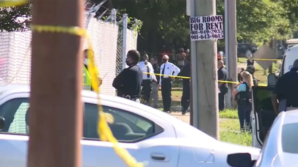 Authorities stand outside the East Lamar Carrier Annex facility in Memphis. Tenn., where two Postal Service employees were killed and a third died after taking their own life, the FBI said. 