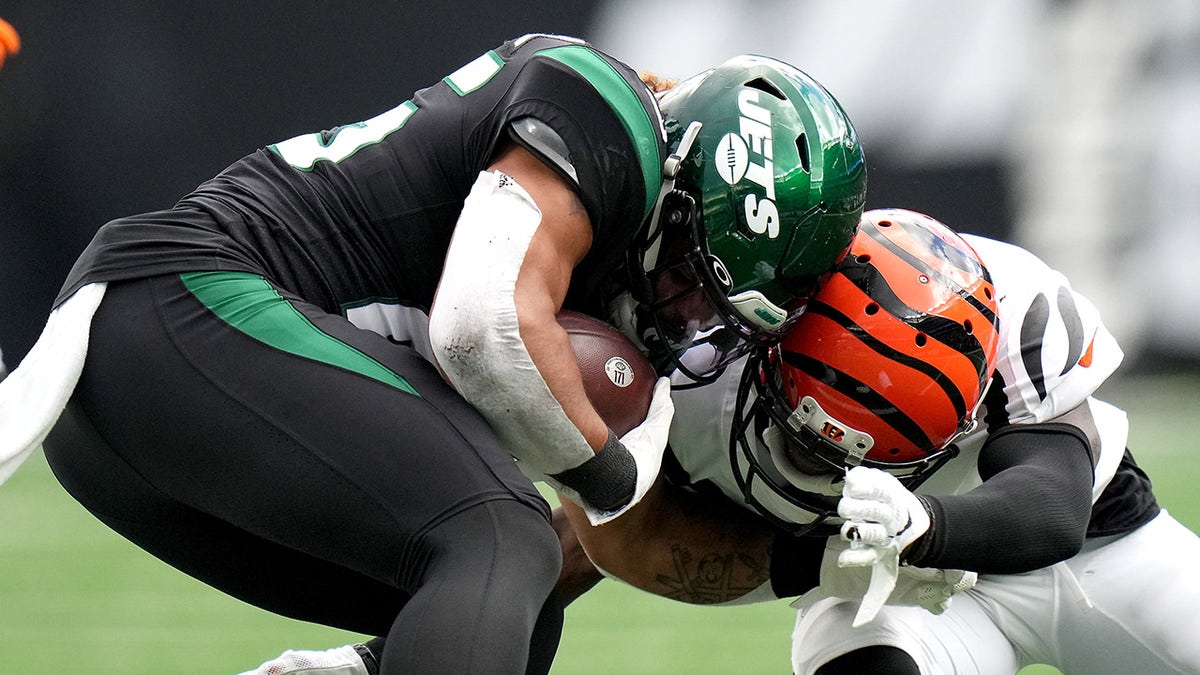 Cincinnati Bengals cornerback Mike Hilton (21) is penalized for a helmet-to-helmet hit on New York Jets running back Ty Johnson (25) in the fourth quarter during a Week 8 game Sunday, Oct. 31, 2021, at MetLife Stadium.