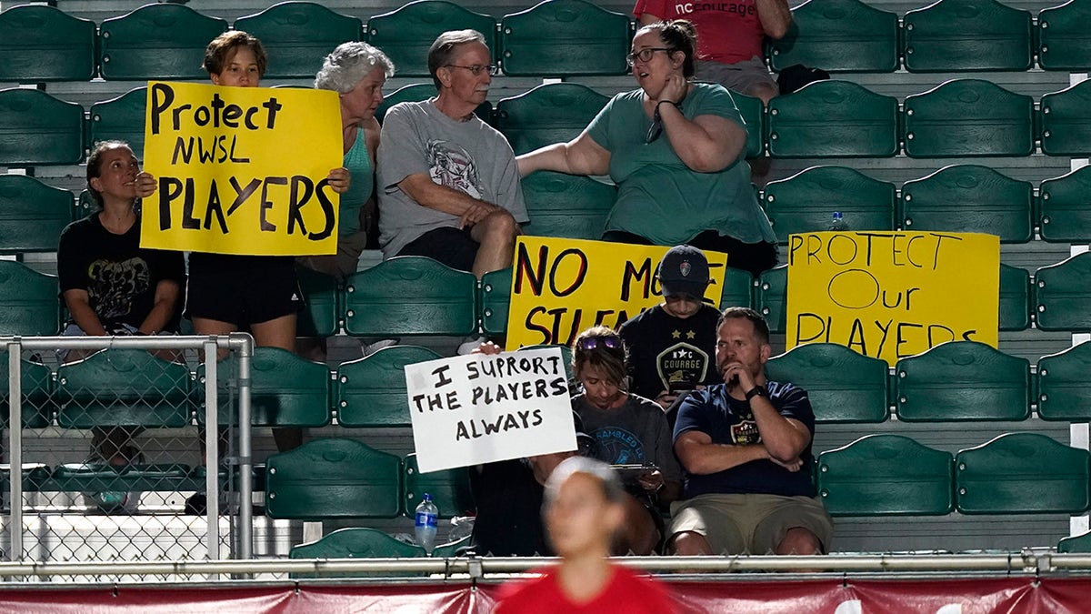 Fans watch during the first half of an NWSL soccer match between the North Carolina Courage and Racing Louisville FC in Cary, N.C., Wednesday, Oct. 6, 2021.