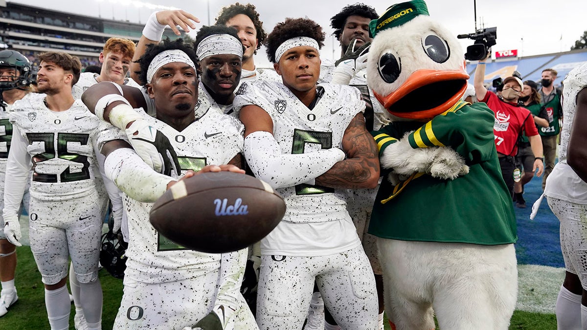 Oregon players and mascot celebrate a win over UCLA in an NCAA college football game Saturday, Oct. 23, 2021, in Pasadena, Calif.