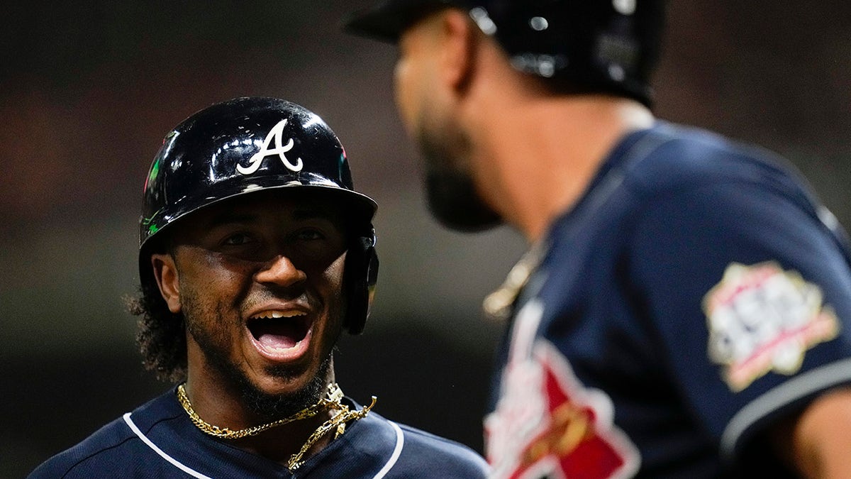Atlanta Braves' Ozzie Albies celebrates after scoring on a double by Austin Riley during the first inning of Game 1 in baseball's World Series between the Houston Astros and the Atlanta Braves Tuesday, Oct. 26, 2021, in Houston.