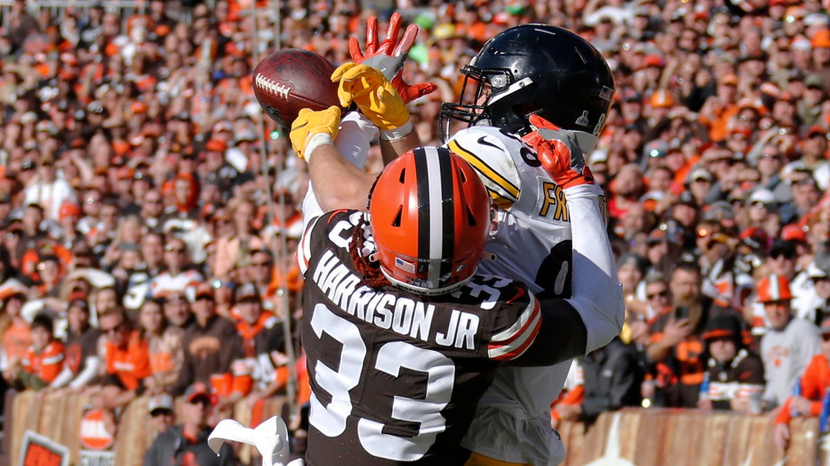 Pittsburgh Steelers tight end Pat Freiermuth catches a 2-yard touchdown pass under pressure from Cleveland Browns defensive back Ronnie Harrison during the second half Sunday, Oct. 31, 2021, in Cleveland.