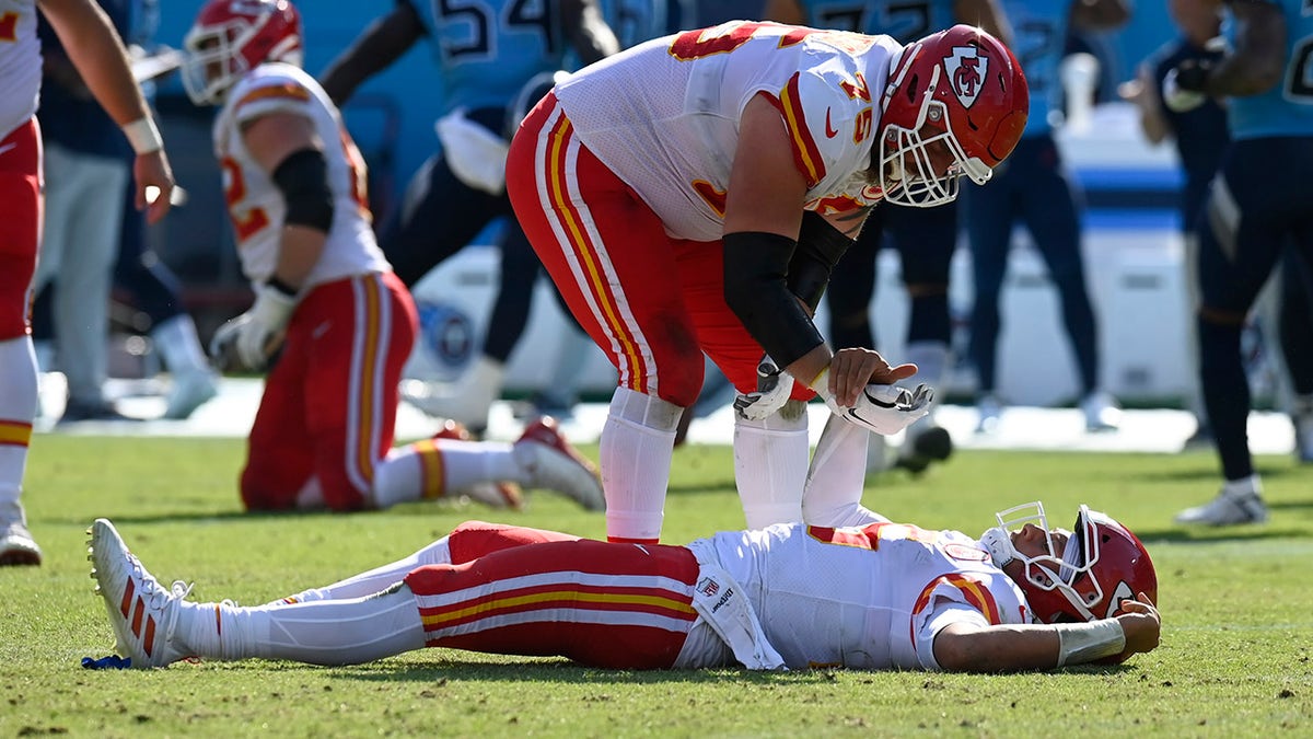 Kansas City Chiefs quarterback Patrick Mahomes is helped up by Mike Remmers (75) after Mahomes was hit in the second half of a game against the Tennessee Titans Sunday, Oct. 24, 2021, in Nashville, Tenn.