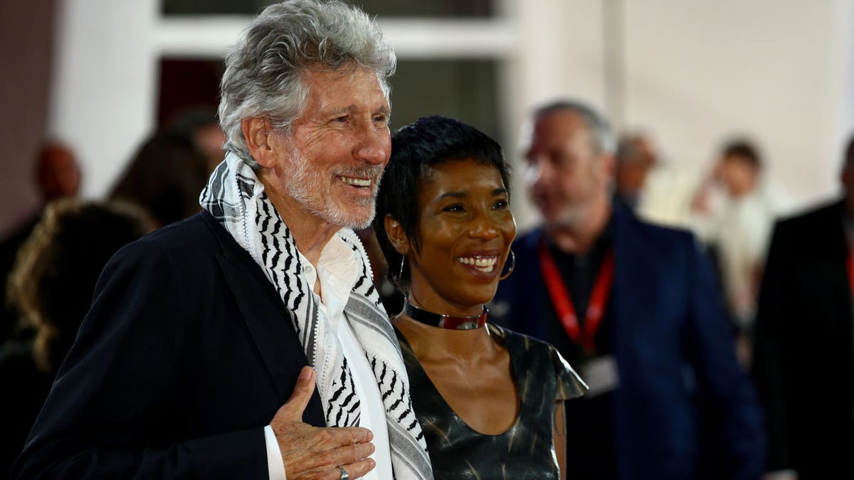 Roger Waters and a guest walk the red carpet ahead of the ‘Roger Waters Us + Them’ screening during the 76th Venice Film Festival at Sala Darsena on September 06, 2019 in Venice, Italy.