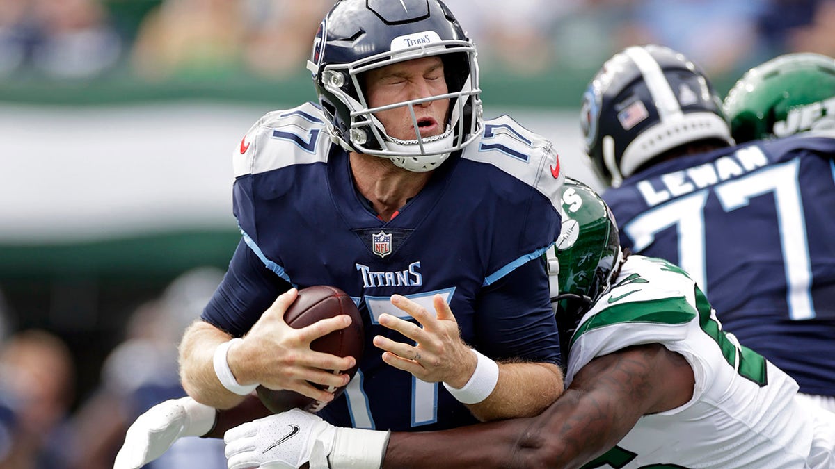Tennessee Titans quarterback Ryan Tannehill (17) is sacked by New York Jets outside linebacker Quincy Williams (56) during an NFL football game, Sunday, Oct. 3, 2021, in East Rutherford, New Jersey.