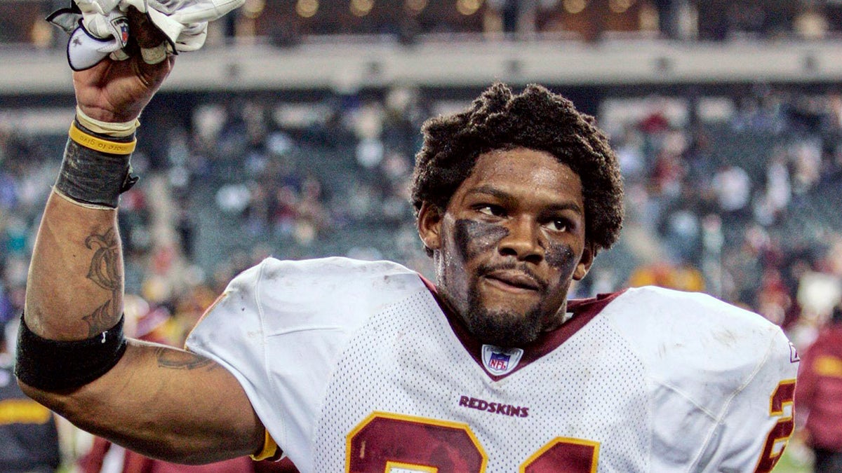 Washington Redskins safety Sean Taylor raises his hand to acknowledge fans after the Redskins defeated the Philadelphia Eagles in Philadelphia in this January 1, 2006 file photograph. Taylor, who was shot and killed at his Florida residence on November 26, 2007, was elected as a starting player to the NFL Pro Bowl posthumously on December 18, 2007.