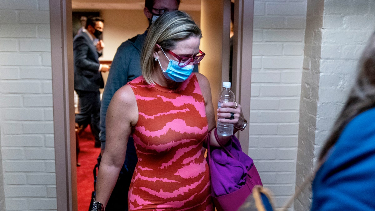 Sen. Kyrsten Sinema, D-Ariz., leaves a private meeting with Joe Manchin, D-W.Va., on Capitol Hill in Washington, Sept. 30, 2021.