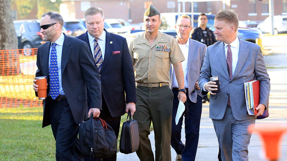Stuart Scheller and lawyers arrive at Camp Lejeune for court martial over criticism of Afghanistan 