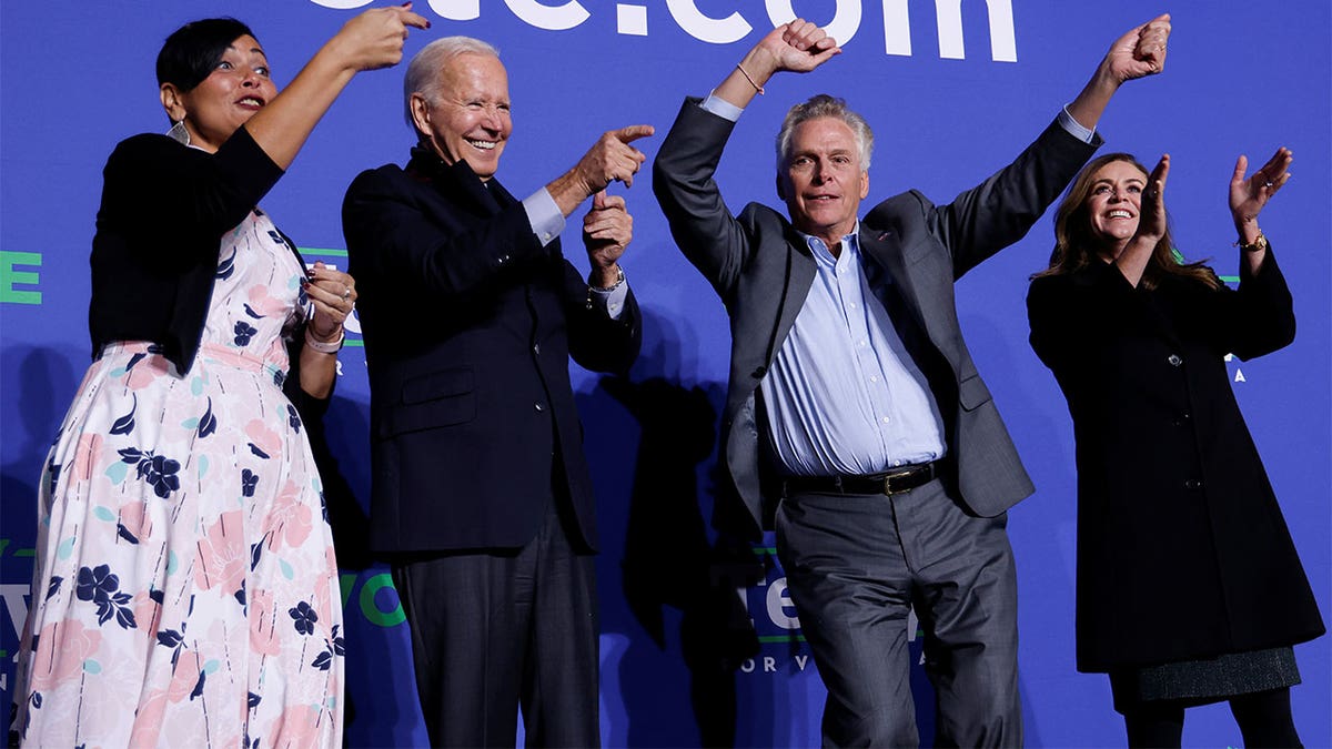 Democratic candidate for governor of Virginia Terry McAuliffe dances onstage next to his wife Dorothy, U.S. President Joe Biden, and Democratic Virginia Lt. Gov. candidate Hala Ayala