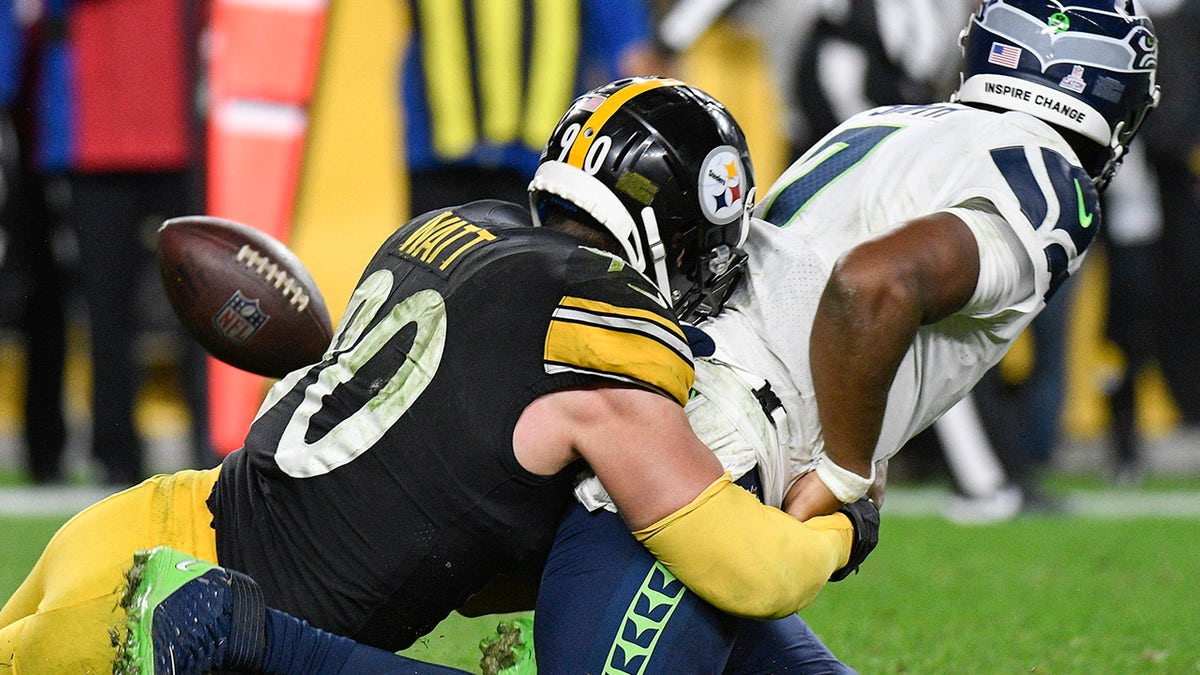 Seattle Seahawks quarterback Geno Smith (7) fumbles as Pittsburgh Steelers outside linebacker T.J. Watt (90) tackles him during overtime Sunday, Oct. 17, 2021, in Pittsburgh.