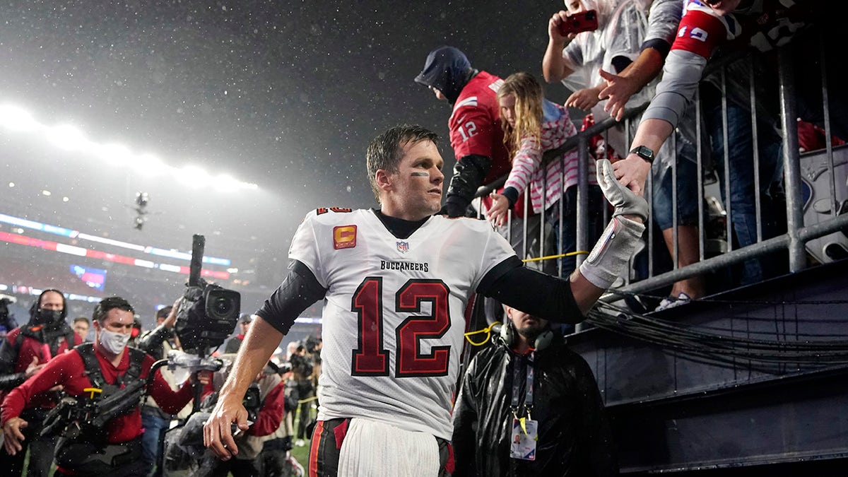 Tampa Bay Buccaneers quarterback Tom Brady (12) is congratulated by fans after defeating the New England Patriots 19-17 in an NFL football game, Sunday, Oct. 3, 2021, in Foxborough, Mass.