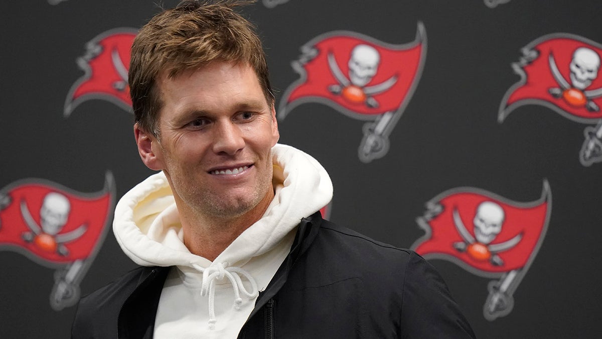 Tampa Bay Buccaneers quarterback Tom Brady smiles while talking with reporters after defeating the New England Patriots 19-17 in an NFL football game, Monday, Oct. 4, 2021, in Foxborough, Mass.