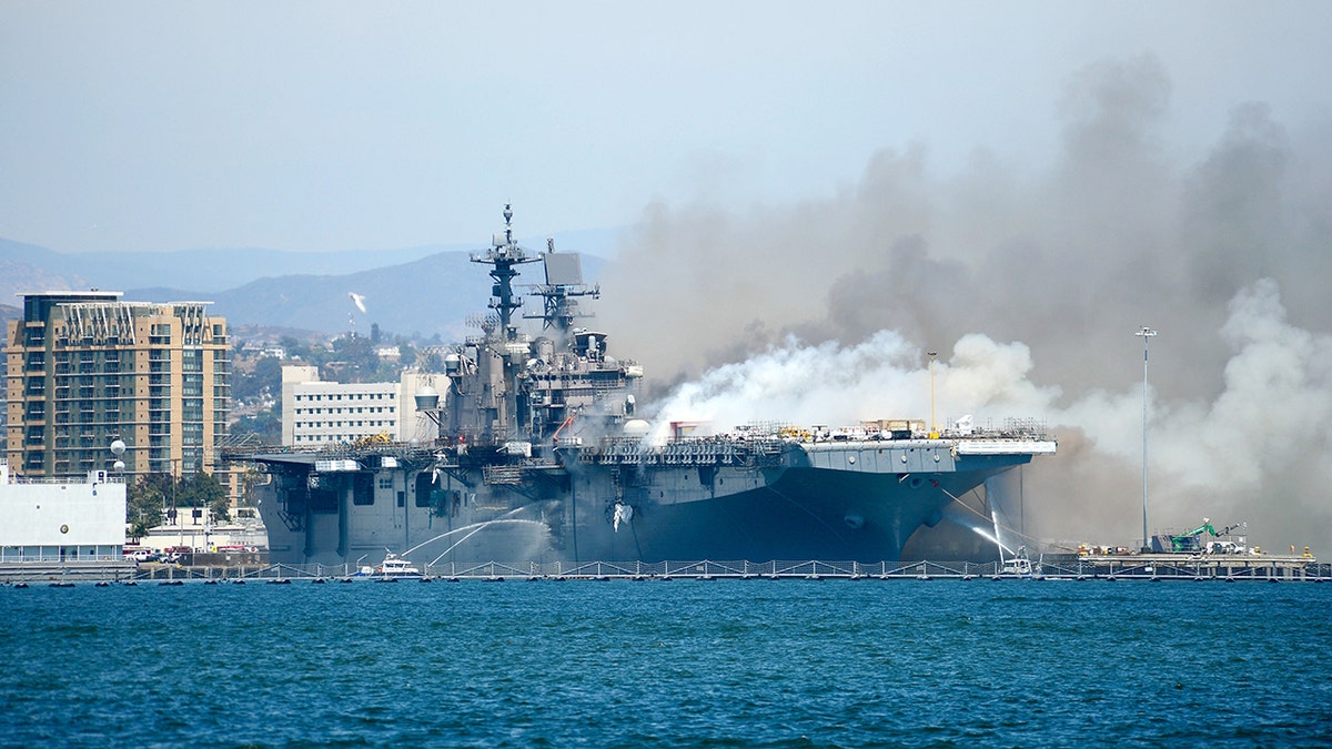 The Port of San Diego Harbor Police Department boats combat a fire aboard the amphibious assault ship USS Bonhomme Richard (LHD 6) at Naval Base San Diego in July 2020.