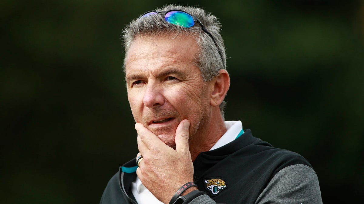 Jacksonville Jaguars head coach Urban Meyer listens to a question during a practice and media availability at Chandlers Cross, England, Oct. 15, 2021.