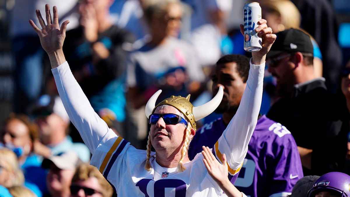 A Minnesota Vikings fan cheers during the second half of an NFL football game between the Carolina Panthers and the Minnesota Vikings, Sunday, Oct. 17, 2021, in Charlotte, N.C.