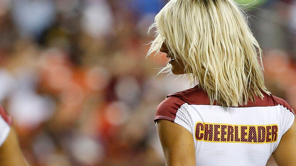 A Washington cheerleader dances on the field during a timeout at FedExField.