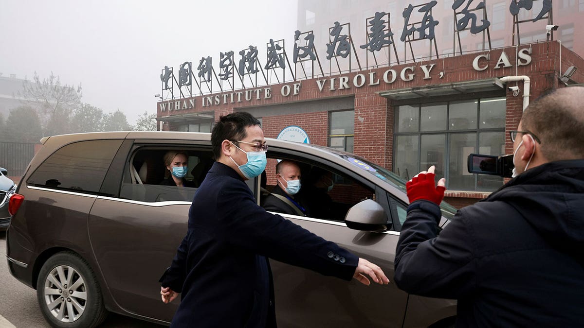 Peter Daszak and Thea Fischer, members of the World Health Organization team tasked with investigating the origins of COVID-19, sit in a car arriving at Wuhan Institute of Virology in Wuhan, Hubei province, China, Feb. 3, 2021.