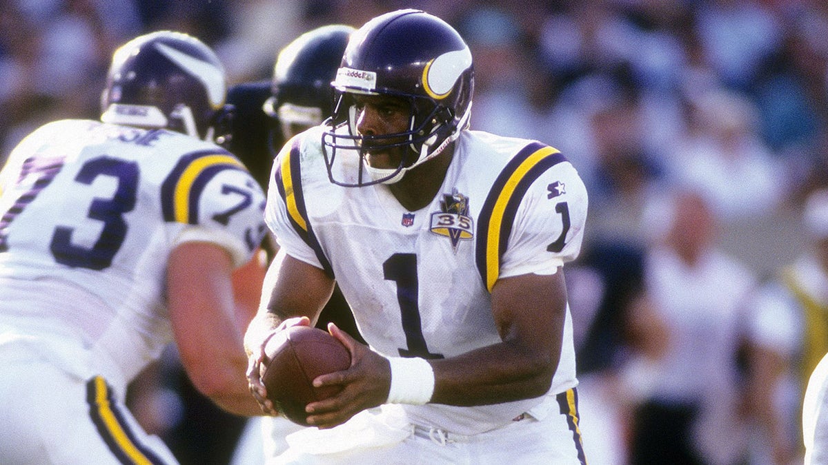 Quarterback Warren Moon of the Minnesota Vikings turns to hand the ball off to a running back against the Chicago Bears during an NFL football game Sept. 3, 1995, at Soldier Field in Chicago, Illinois. Moon played for the Vikings from 1994-96.