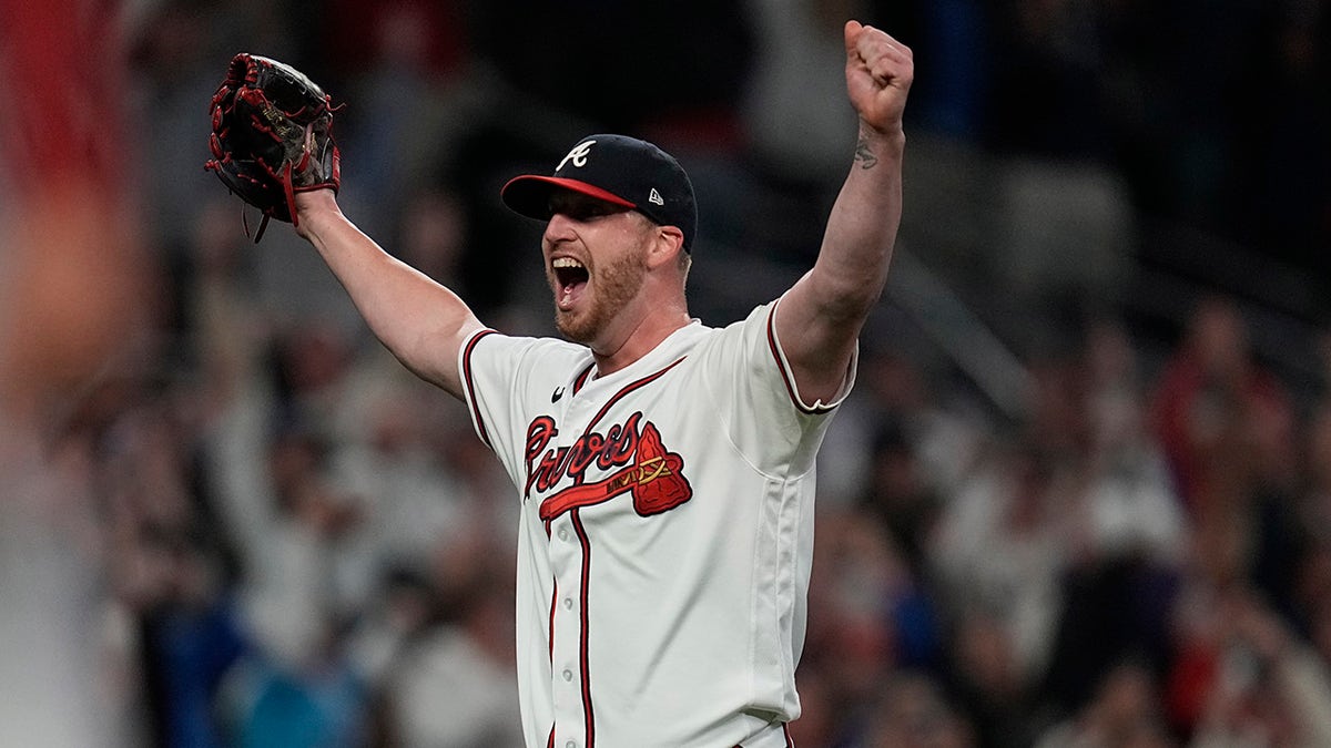Atlanta Braves relief pitcher Will Smith celebrates after winning Game 6 of baseball's National League Championship Series against the Los Angeles Dodgers Sunday, Oct. 24, 2021, in Atlanta. The Braves defeated the Dodgers 4-2 to win the series.