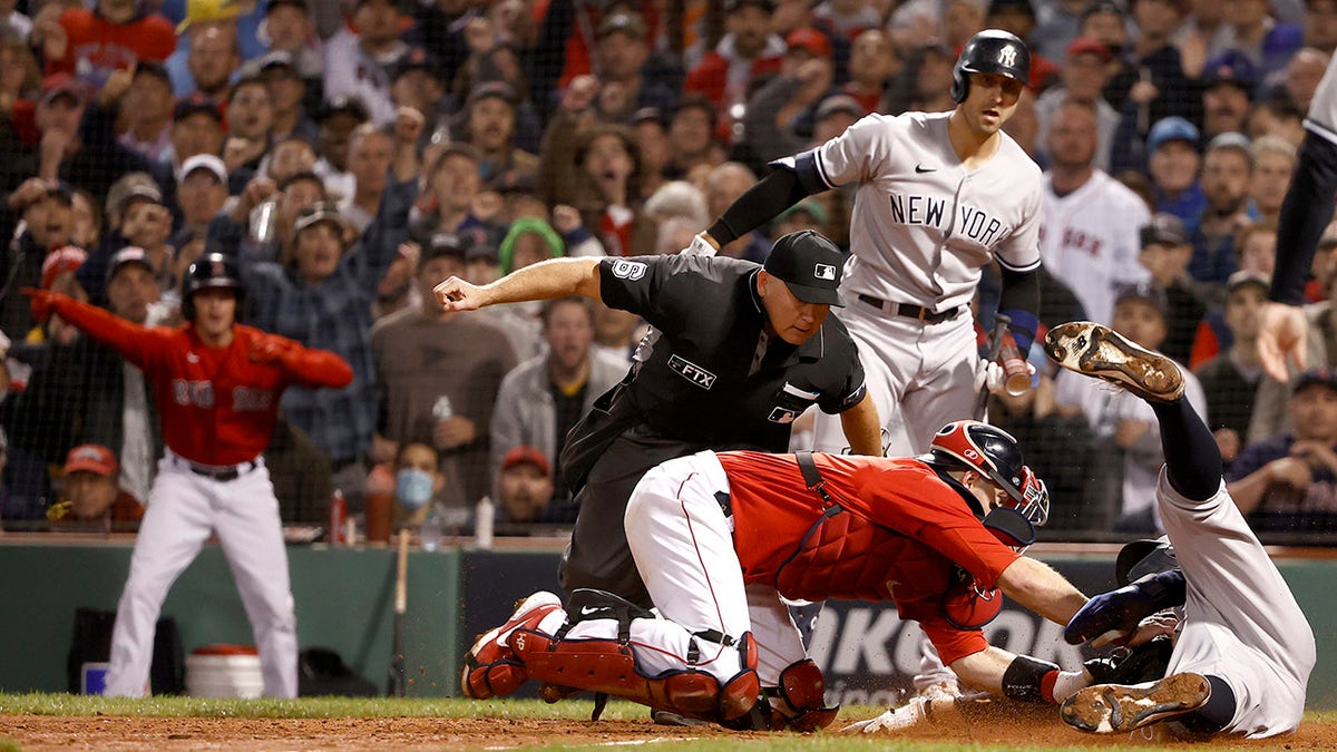 Aaron Judge of the New York Yankees is tagged out by Kevin Plawecki of the Boston Red Sox during the sixth inning of the American League Wild Card game at Fenway Park on Oct. 5, 2021, in Boston, Massachusetts.