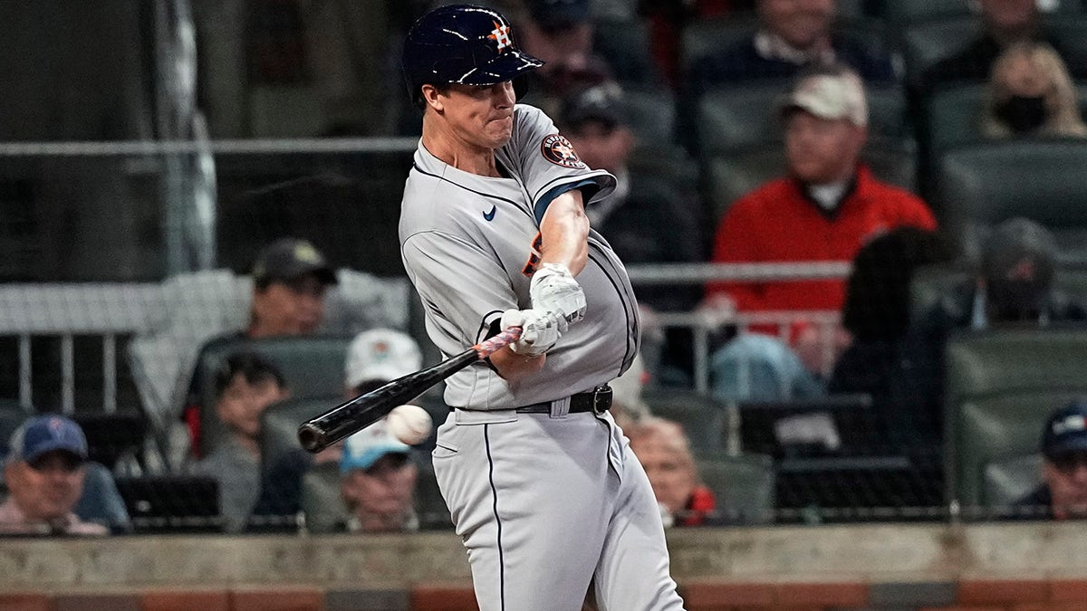 Houston Astros' Zack Greinke hits a single during the second inning in Game 4 of baseball's World Series between the Houston Astros and the Atlanta Braves Saturday, Oct. 30, 2021, in Atlanta.