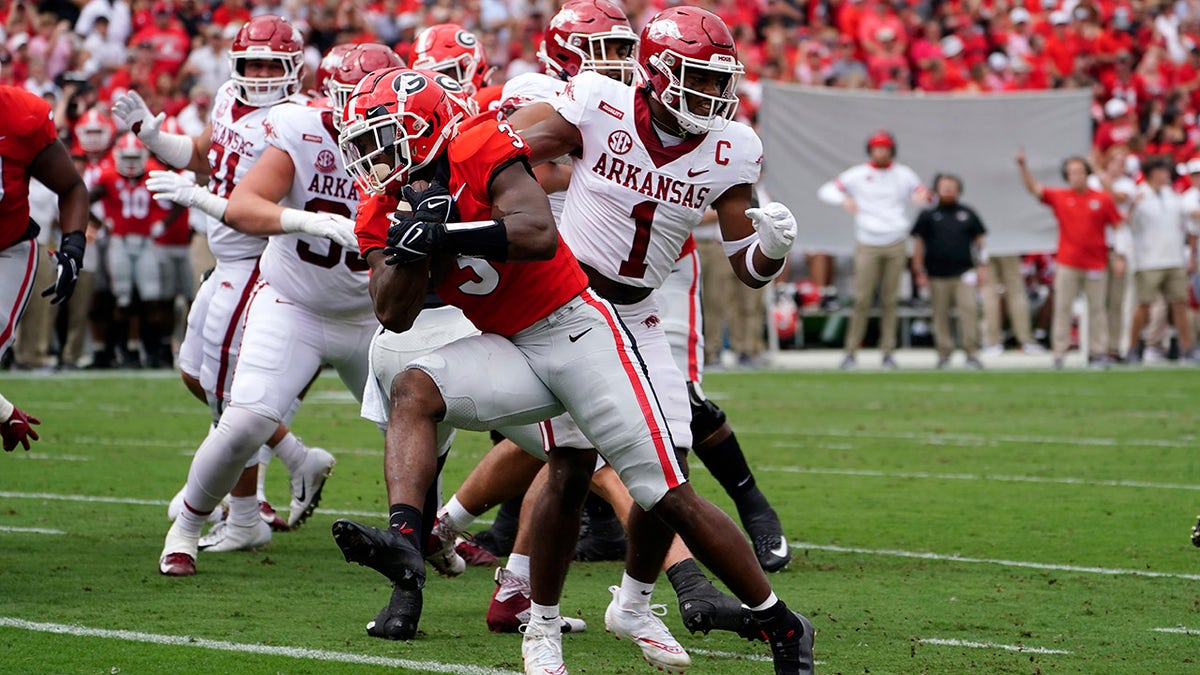 Georgia running back Zamir White (3) gets past Arkansas defensive back Jalen Catalon (1) to score a touchdown during the first half of an NCAA college football game Saturday, Oct. 2, 2021, in Athens, Ga..