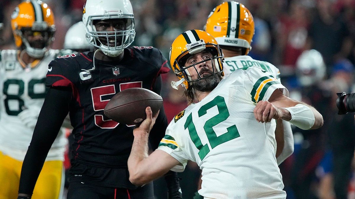 Green Bay Packers quarterback Aaron Rodgers (12) throws the ball into the crowd as time expires during the second half of an NFL football game against the Arizona Cardinals, Thursday, Oct. 28, 2021, in Glendale, Ariz. The Packers won 24-21.