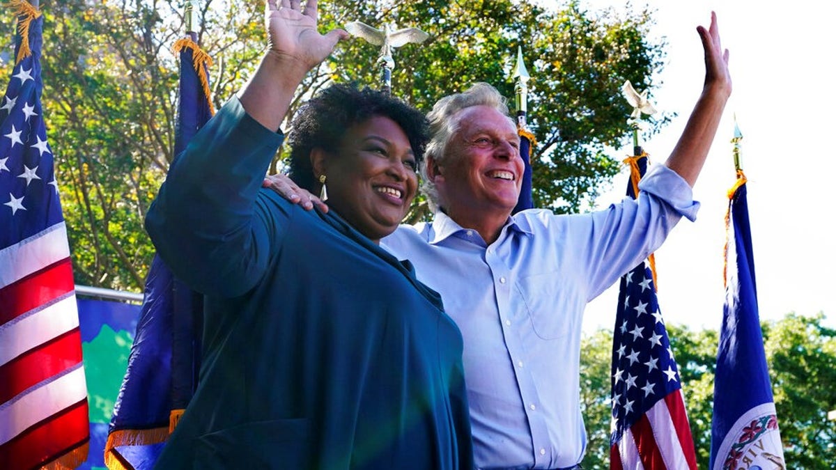 Stacey Abrams waves to crowd with Democratic gubernatorial candidate, former Virginia Gov. Terry McAuliffe