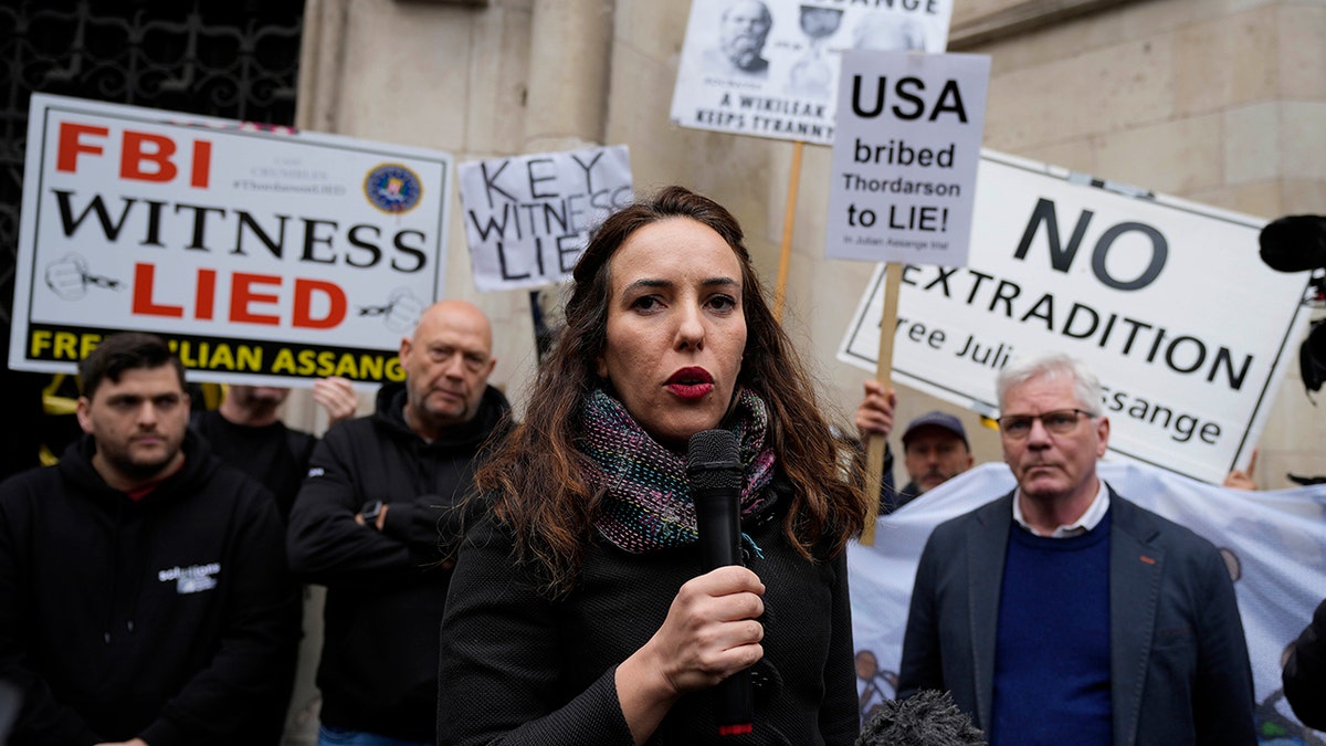 CAPTION CORRECTION SURNAME Julian Assange's partner, Stella Moris, addresses protestors outside the High Court in London, Wednesday, Oct. 27, 2021. The U.S. government is scheduled to ask Britain's High Court to overturn a judge's decision that WikiLeaks founder Julian Assange should not be sent to the United States to face espionage charges. A lower court judge refused extradition in January on health grounds, saying Assange was likely to kill himself if held under harsh U.S. prison conditions. (AP Photo/Frank Augstein)