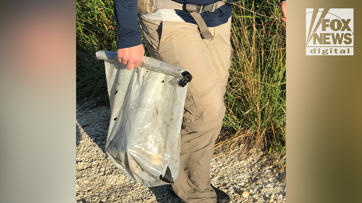 Chris and Roberta Laundrie in the Myakkahatchee Creek Environmental Park on the day authorities found their son's remains and personal belongings, including this dry bag