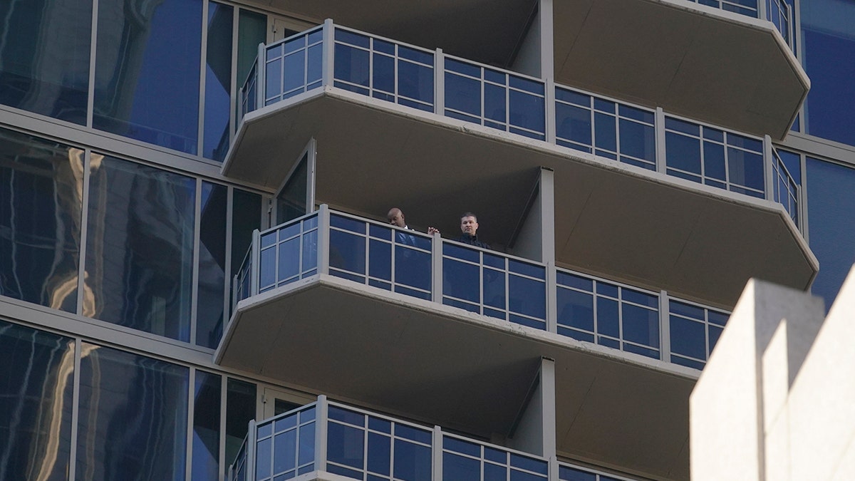 Authorities gather on a balcony in a residential building on Wednesday in Atlanta. 