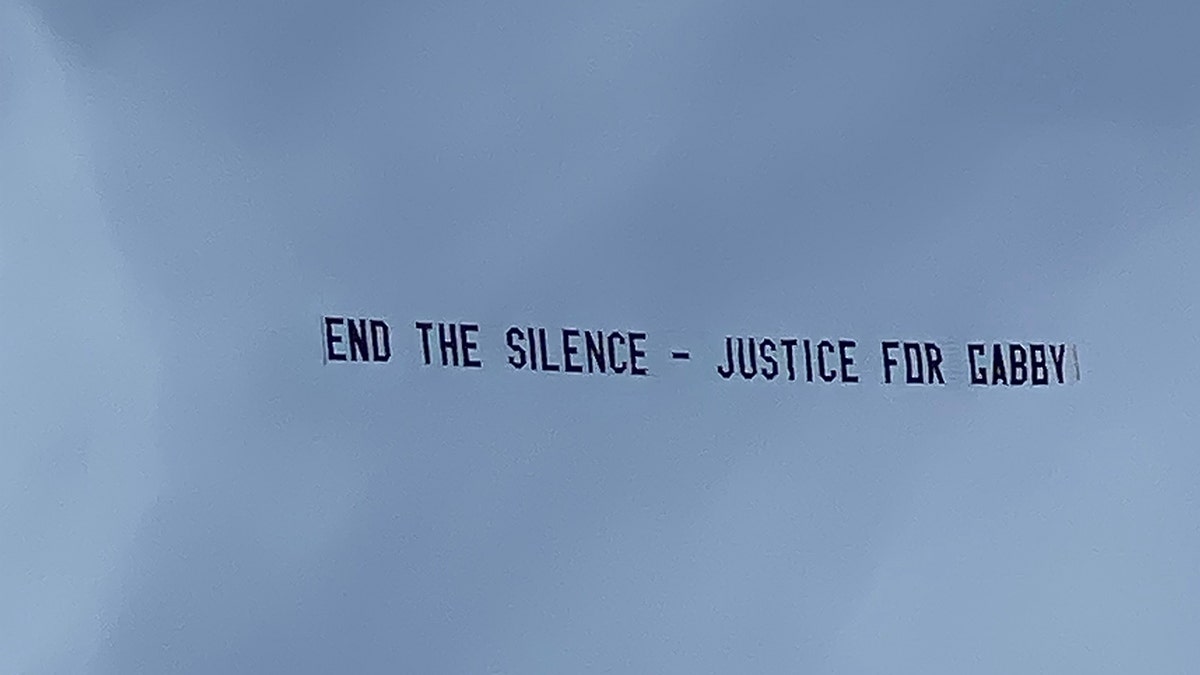 Justin Shepherd raised funds from his TikTok followers to fly this banner over Brian Laundrie's home in North Port, Fla.