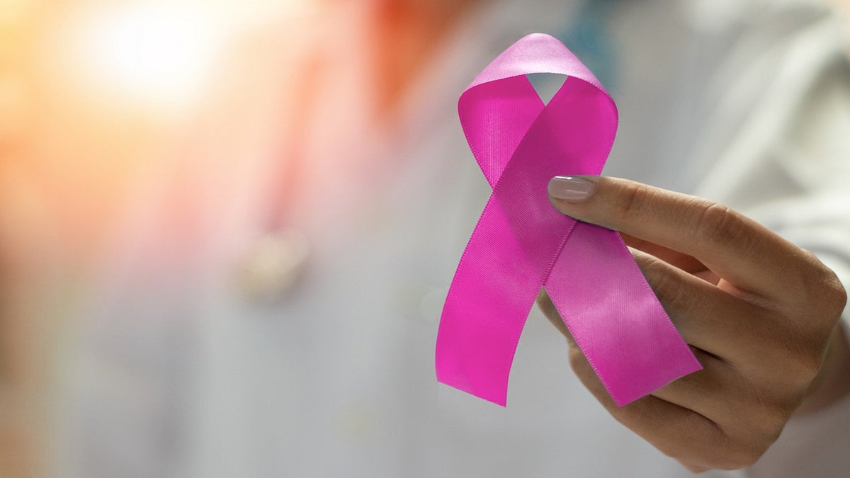 woman holding breast cancer awareness ribbon