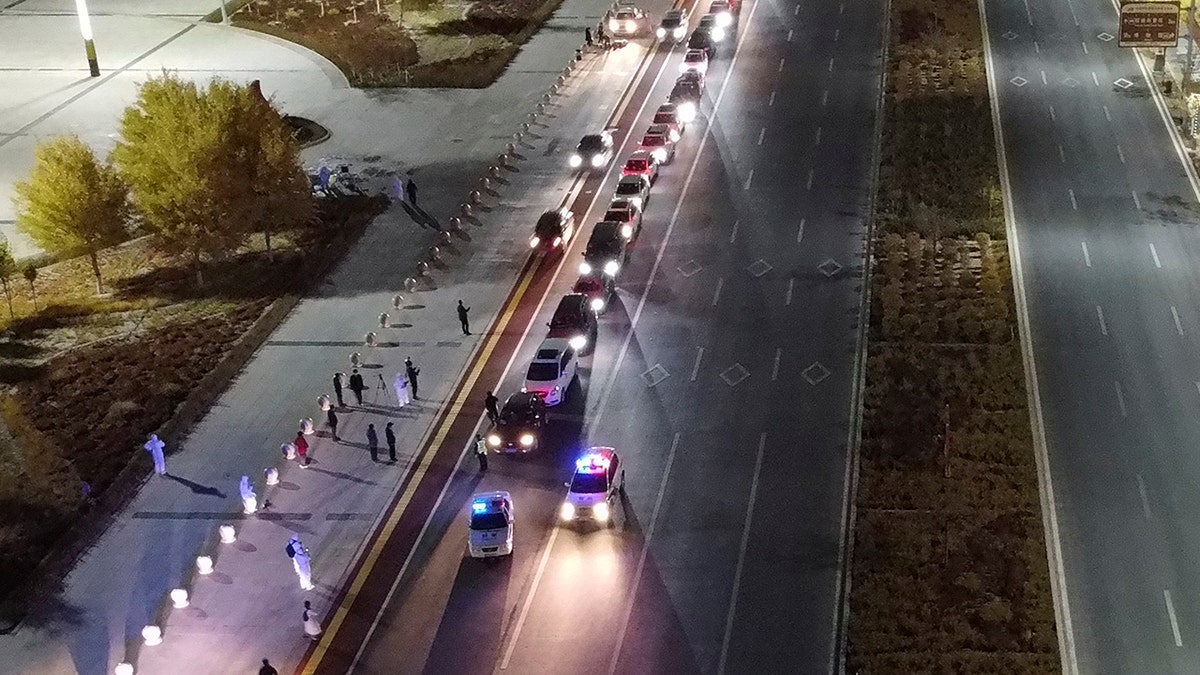 In this aerial photo released by Xinhua News Agency, stranded self driving tourists prepare to leave Ejina Banner of Alxa League to head to quarantine hotels for two weeks, in northern China's Inner Mongolia Autonomous Region on Thursday.