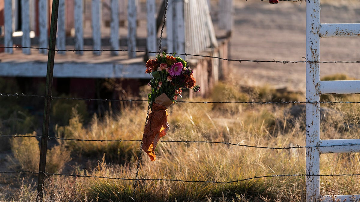 A bouquet of flowers is left to honor cinematographer Halyna Hutchins outside the Bonanza Creek Ranch in Santa Fe, N.M