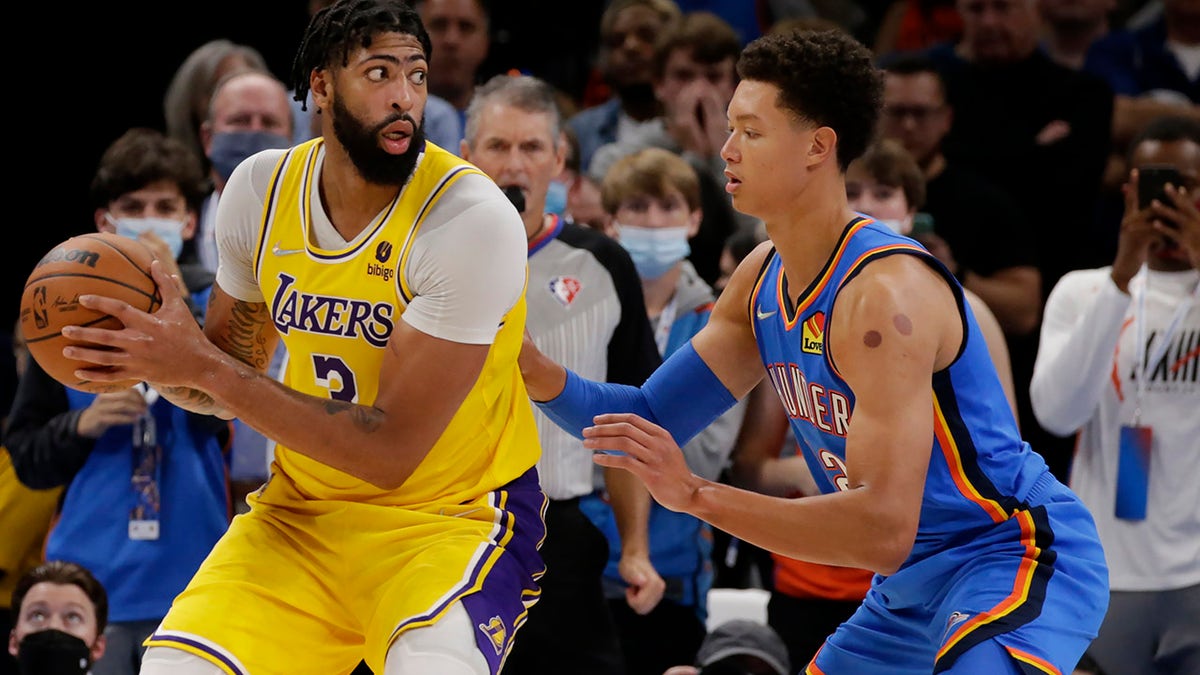 Los Angeles Lakers forward Anthony Davis (3) goes against Oklahoma City Thunder center Isaiah Roby (22) during the second half of an NBA basketball game, Wednesday, Oct. 27, 2021, in Oklahoma City.