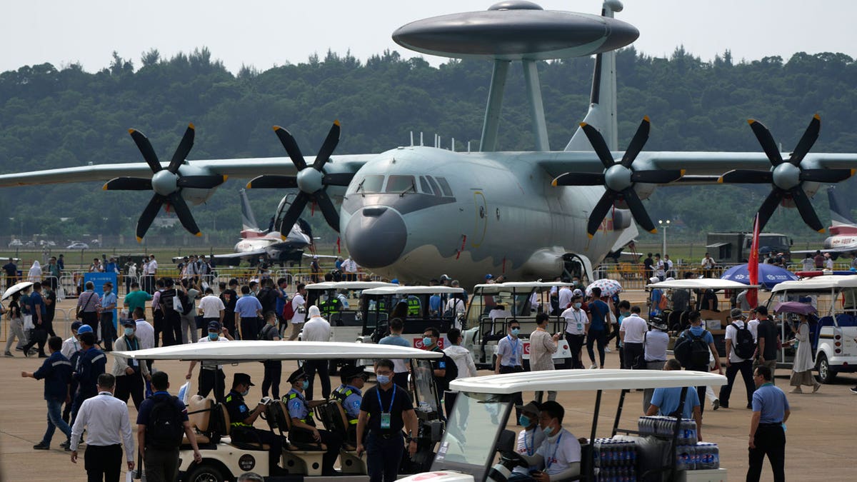 Visitors look at the Chinese military's KJ-500 airborne early warning and control aircraft during 13th China International Aviation and Aerospace Exhibition, also known as Airshow China 2021, on Wednesday, Sept. 29, 2021, in Zhuhai in southern China's Guangdong province. With record numbers of military flights near Taiwan over the last week, China has been stepping up its harassment of the island it claims as its own, showing an new intensity and sophistication as it asserts its territorial claims in the region. (AP Photo/Ng Han Guan