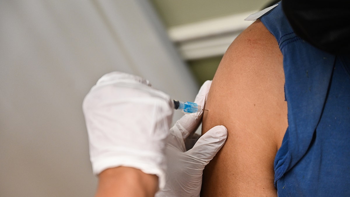 A man receives the Moderna COVID-19 vaccine while at a federally qualified health center in Westbury, New York, April 29, 2021.