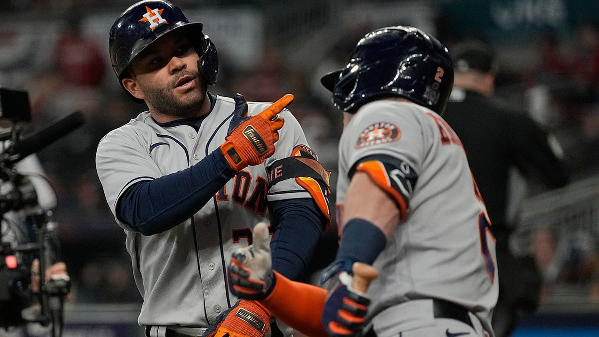 Houston Astros' Jose Altuve celebrates his home run with Alex Bregman during the fourth inning in Game 4 of baseball's World Series between the Houston Astros and the Atlanta Braves Saturday, Oct. 30, 2021, in Atlanta.
