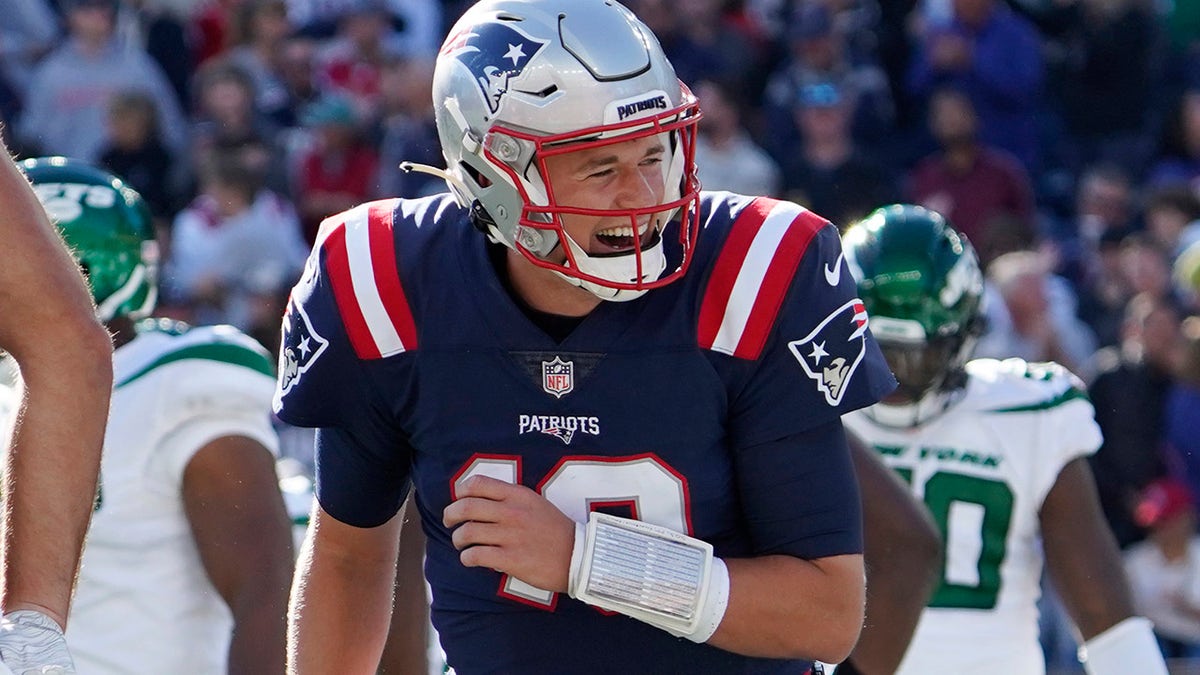 New England Patriots quarterback Mac Jones (10) celebrates after a touchdown by Hunter Henry during the first half of a game against the New York Jets Sunday, Oct. 24, 2021, in Foxborough, Mass.