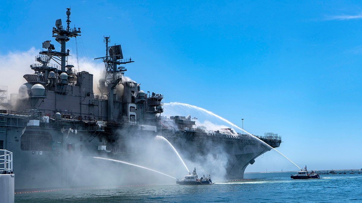 The Port of San Diego Harbor Police Department boats combat a fire aboard the amphibious assault ship USS Bonhomme Richard (LHD 6) at Naval Base San Diego in July 2020.