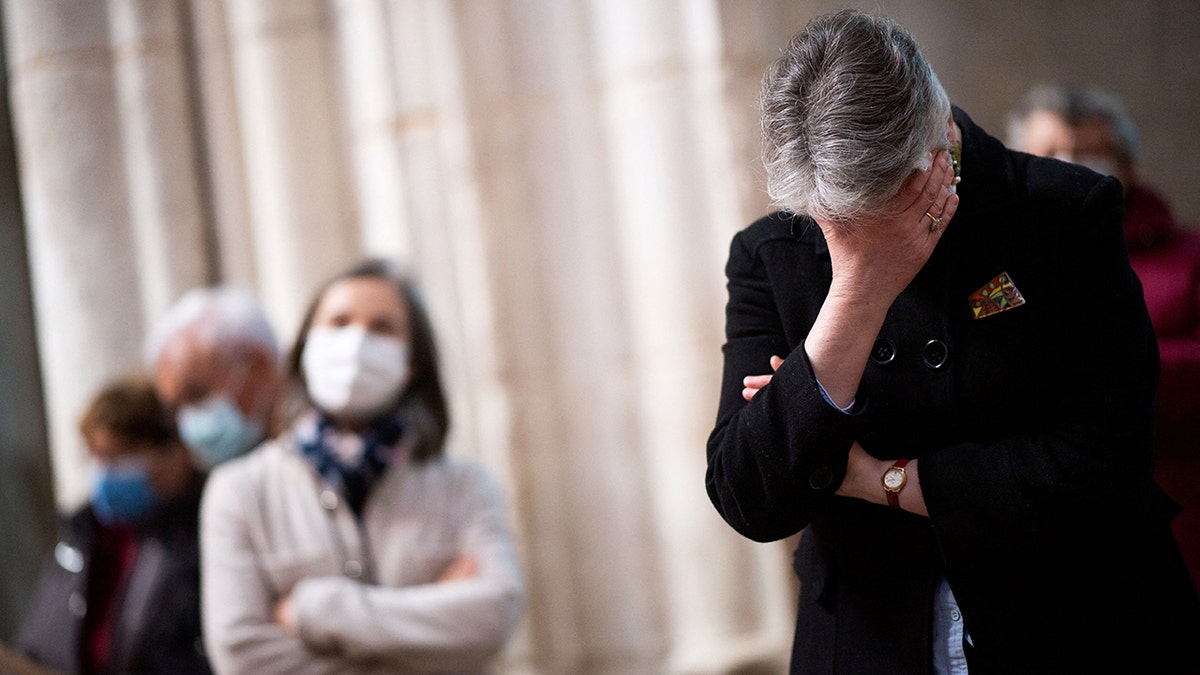 A believer reacts while praying during a mass in the Cathedral of Lucon, western France, on March 14, 2021, organised after the unveiling ceremony of a plaque in tribute to children victims of sexual abuse by priests. (Photo by LOIC VENANCE / AFP) (Photo by LOIC VENANCE/AFP via Getty Images)