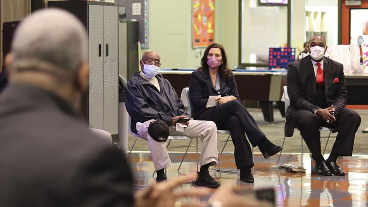Gov. Gretchen Whitmer, second from right, visits Benton Harbor, Michigan, Tuesday, Oct. 19, 2021, to listen to residents who have been urged to use bottled water because of elevated levels of lead in their tap water. (Michigan Office of the Governor via AP